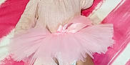 Miah is registered to the contest to win money with this photo: baby, infant, pink, tutu, headband, bow, cast, leg_cast, blanket, striped, diaper, clothing, cute, child, laying_down, foot, face, expression, soft_texture, indoors