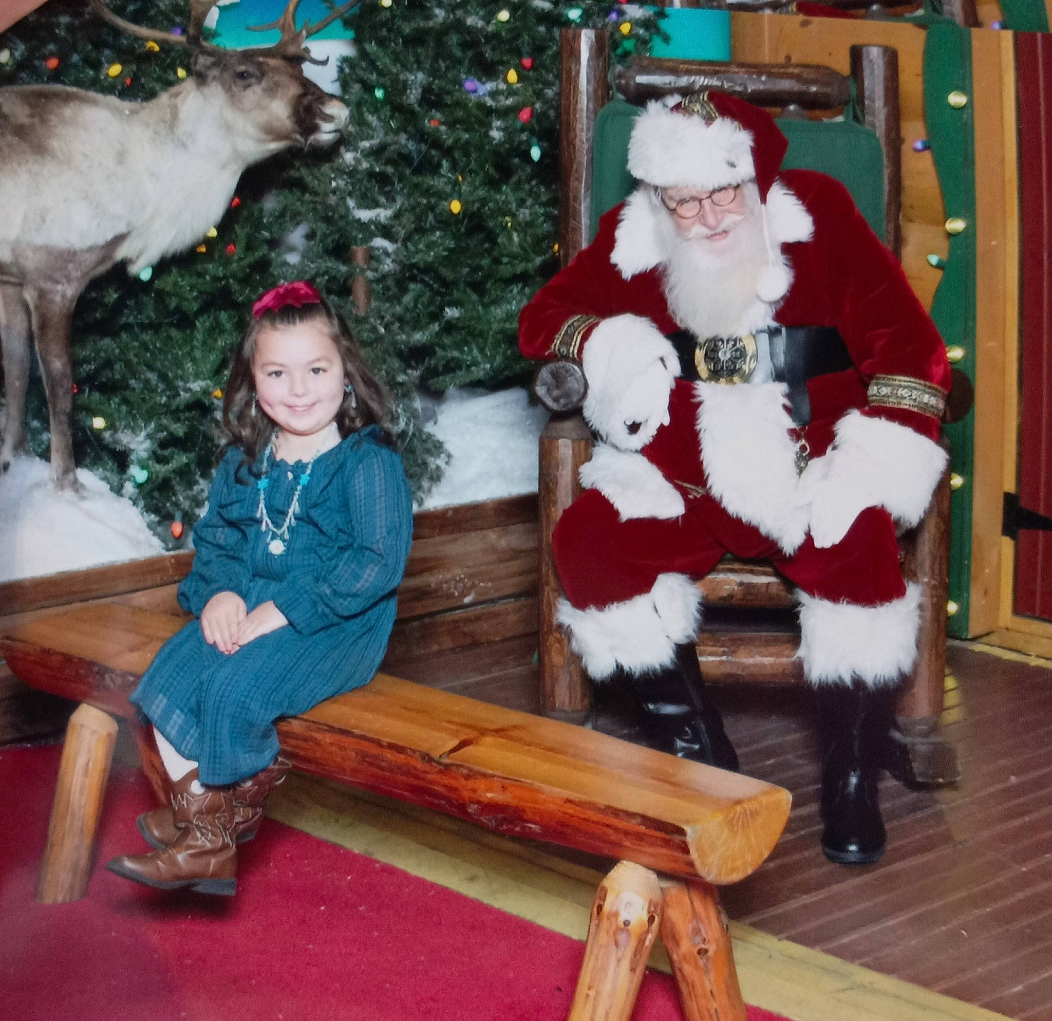 Cecily joined the competition — help win amazing prizes! christmas, christmas_decoration, christmas_eve, christmas_ornament, christmas_tree, event, fun, fur_clothing, happy, hat, holiday, joy, lap, mammal, person, santa_claus, smile, toddler, tree, white