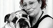 Olymph participe au concours pour gagner de l'argent avec cette photo : woman, person, dog, bulldog, pet, animal, portrait, hugging, cuddling, smiling, glasses, curly_hair, necklace, black_and_white, wrinkles, short_muzzle, indoors, curtain, affection, memories