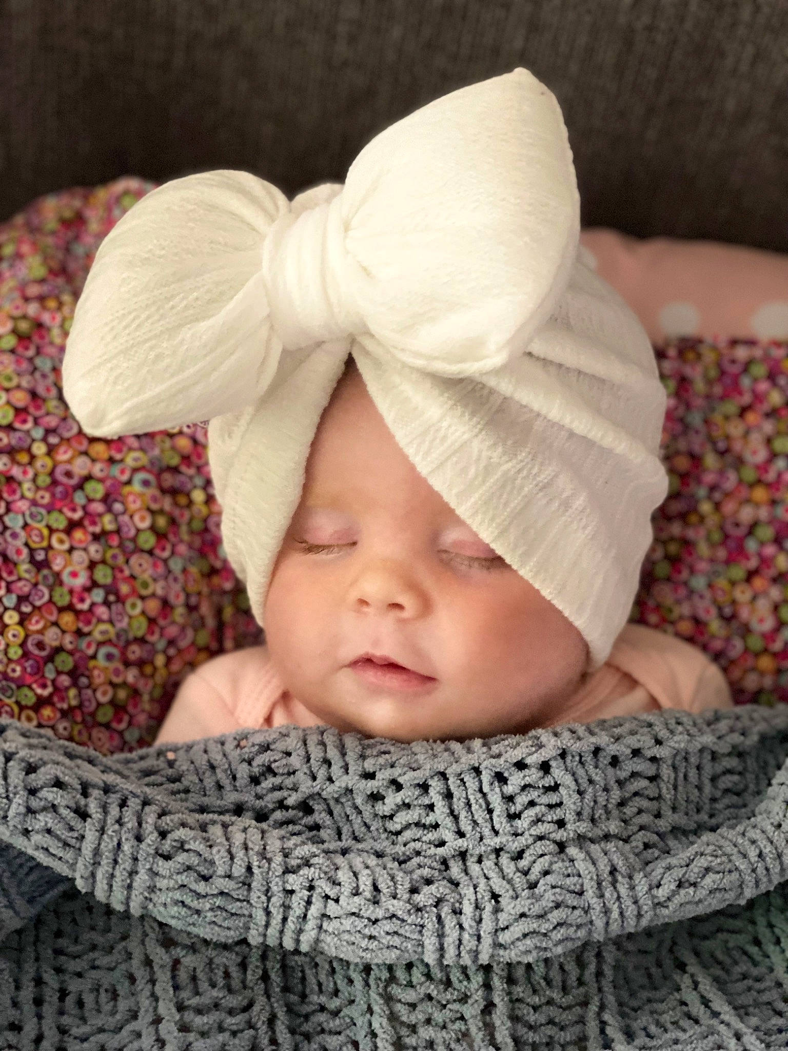 Riley is registered to the contest to win money with this photo: baby, baby_sleeping, baby_toddler_clothing, cap, child, comfort, face, fashion_accessory, fur, hair_accessory, happy, headband, headpiece, knit_cap, linens, pattern, person, petal, sleeve, toddler