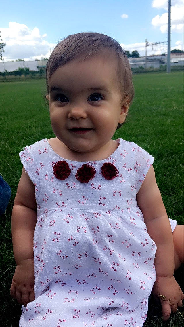 Kiara a rejoint le concours — aidez-le/la à gagner de superbes lots ! baby_toddler_clothing, child, cloud, day_dress, grass, green, hairstyle, happy, joy, lip, one_piece_garment, pattern, person, pink, plant, skin, sky, sleeve, smile, standing