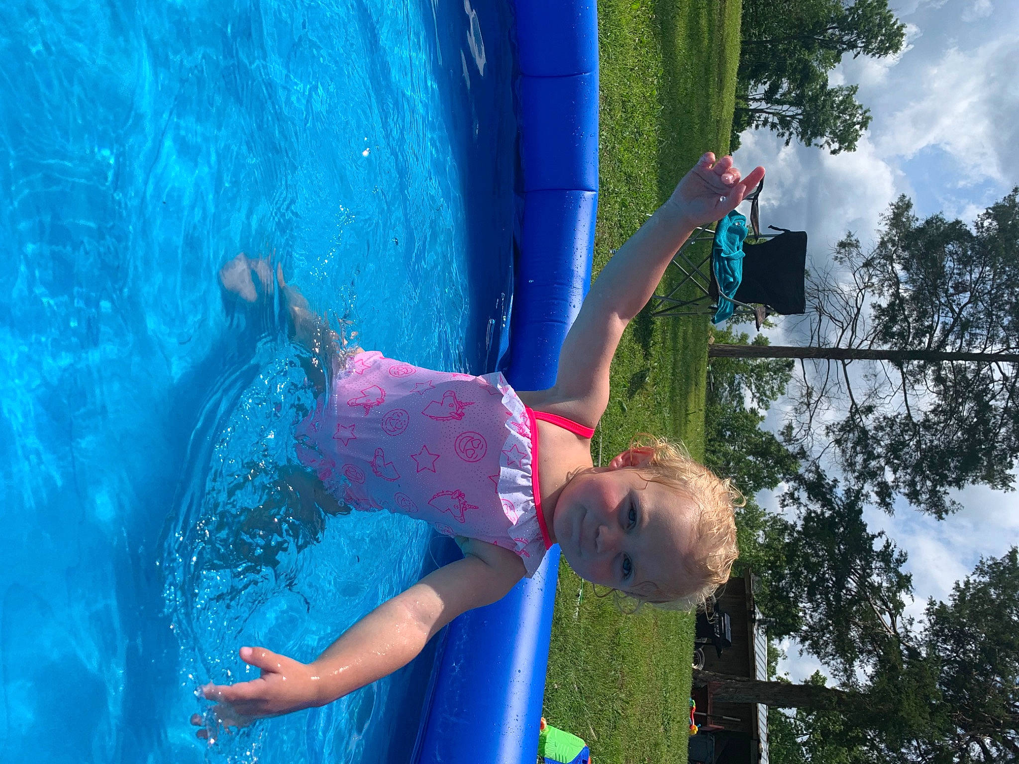 Huntleigh is registered to the contest to win money with this photo: azure, blue, child, chute, cloud, elbow, electric_blue, fun, grass, happy, leisure, outdoor_play_equipment, people_in_nature, person, photograph, play, recreation, sky, toddler, tree