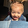 toddler, child, smiling, denim_jacket, pigtails, happy, indoor, light, face, person, jeans, closeup, cute, young_child, playful, hair, portrait, baby, clothing, expression