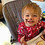Holli joined the competition — help win amazing prizes! toddler, child, high_chair, face, messy, chocolate, toast, food, smile, happy, indoor, clothing, pink, floral_pattern, hand, hair, eyes, mouth, table, breakfast