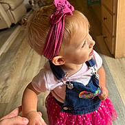 Holli is registered to the contest to win money with this photo: toddler, child, indoor, holding_hand, pink_headband, denim_overalls, colorful_clothing, curious, wooden_floor, person, infant, cute, baby, hand, casual, young_child, portrait, small, cute_outfit, innocence