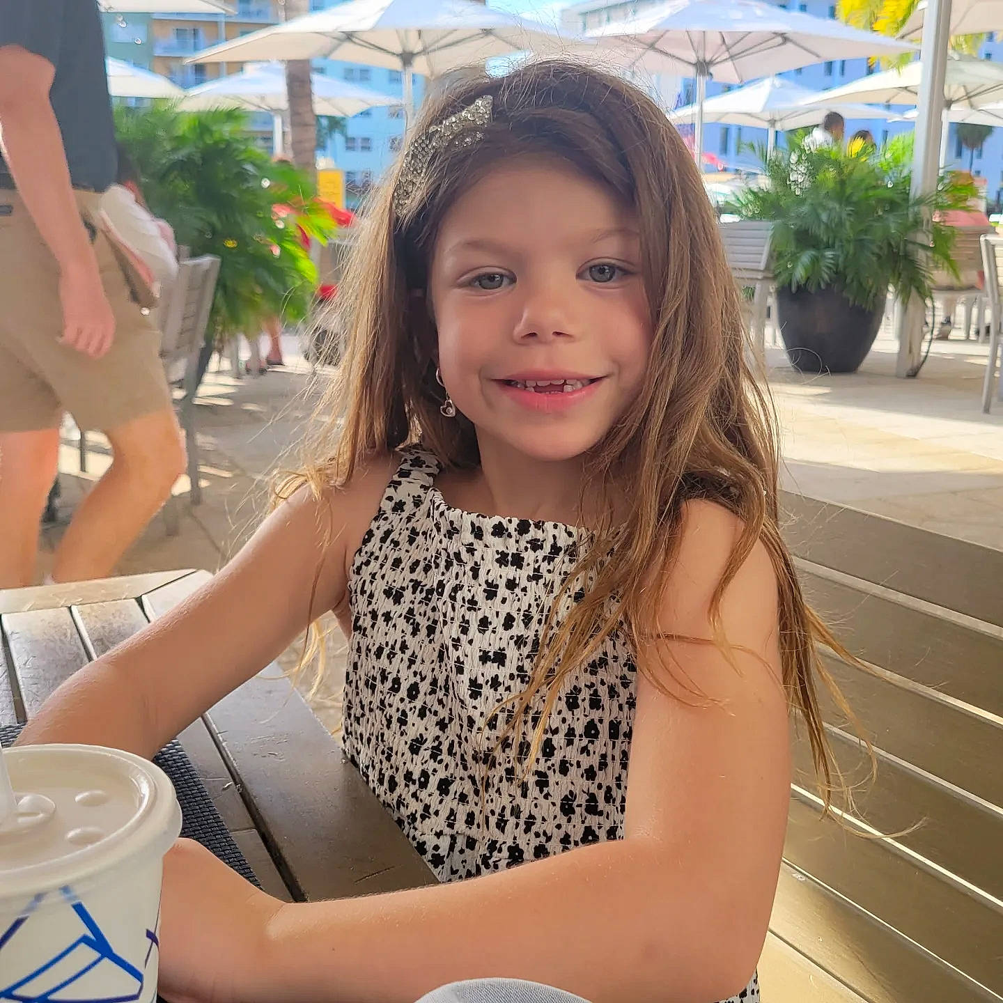 Charlie is registered to the contest to win money with this photo: chair, child, fun, grass, hair, happy, human_leg, joy, leisure, long_hair, morning, person, plant, recreation, shorts, sitting, smile, summer, thigh, travel