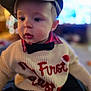 baby, bow_tie, cap, child, closeup, clothing, cute, expression, face, fashion, hat, holiday, indoor, infant, person, portrait, soft_focus, sweater, warm_lighting, young_child