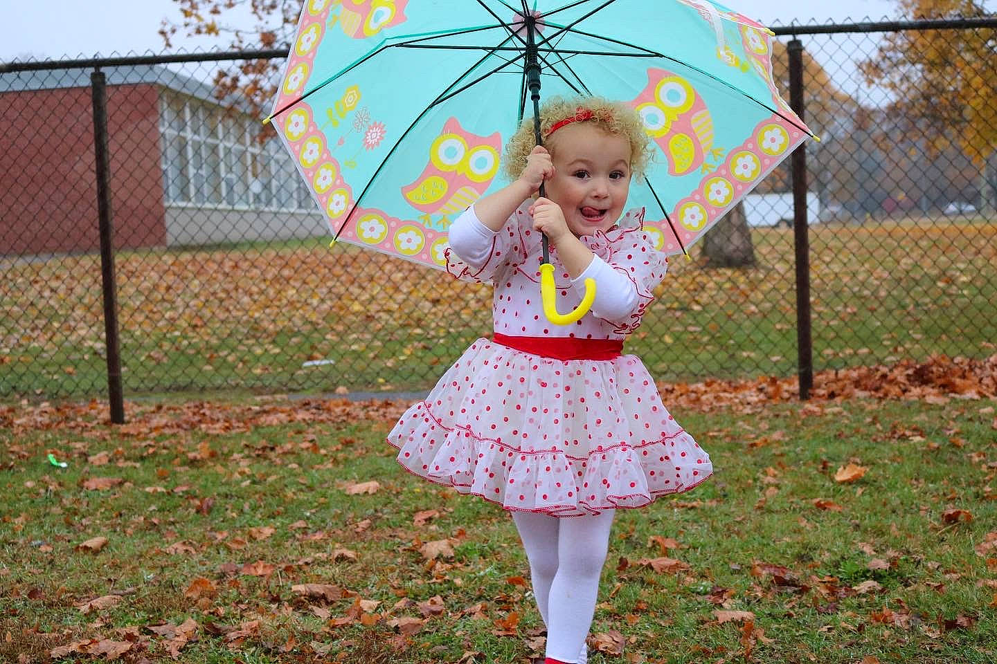 Aurora Ryckman joined the competition — help win amazing prizes! baby_toddler_clothing, dress, fence, fun, grass, happy, lawn, leaf, leisure, nature, pattern, people_in_nature, person, plant, public_space, recreation, sky, toddler, tree, umbrella
