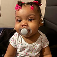 Weylyn joined the competition — help win amazing prizes! baby, child, infant, portrait, sitting, pacifier, hair_bows, pink_bows, smiling, face, eyes, earrings, polka_dot_shirt, short_sleeves, indoors, chair, furniture, close_up, adorable, photograph