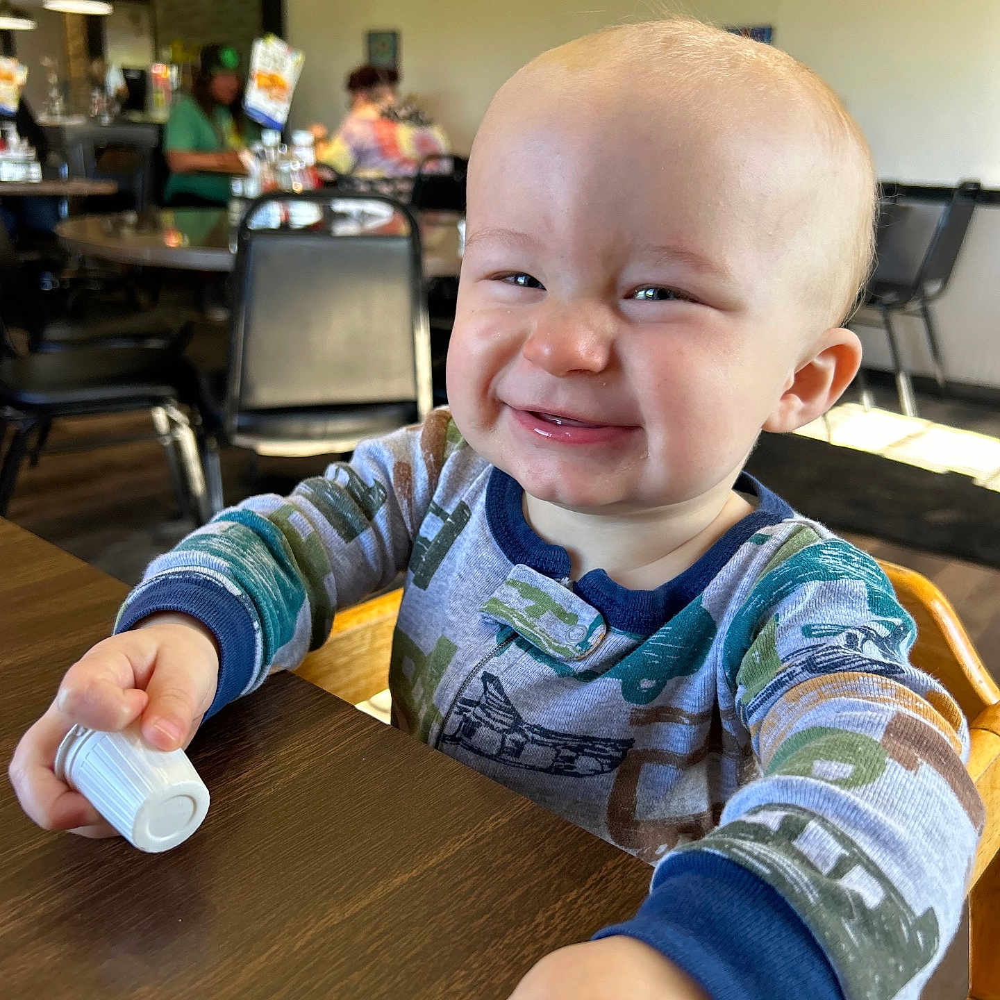 Lawrence joined the competition — help win amazing prizes! adult, baby, bodypart, chair, clothing, face, female, finger, furniture, hand, hat, head, indoors, interiordesign, person, photography, portrait, sitting, table, woman