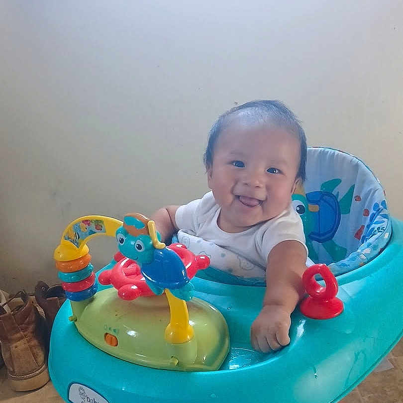 Xavier joined the competition — help win amazing prizes! baby, walker, toy, smiling, indoor, child, floor, footwear, happy, face, person, playful, colorful, seat, infant, cute, tongue, clothing, home, fun