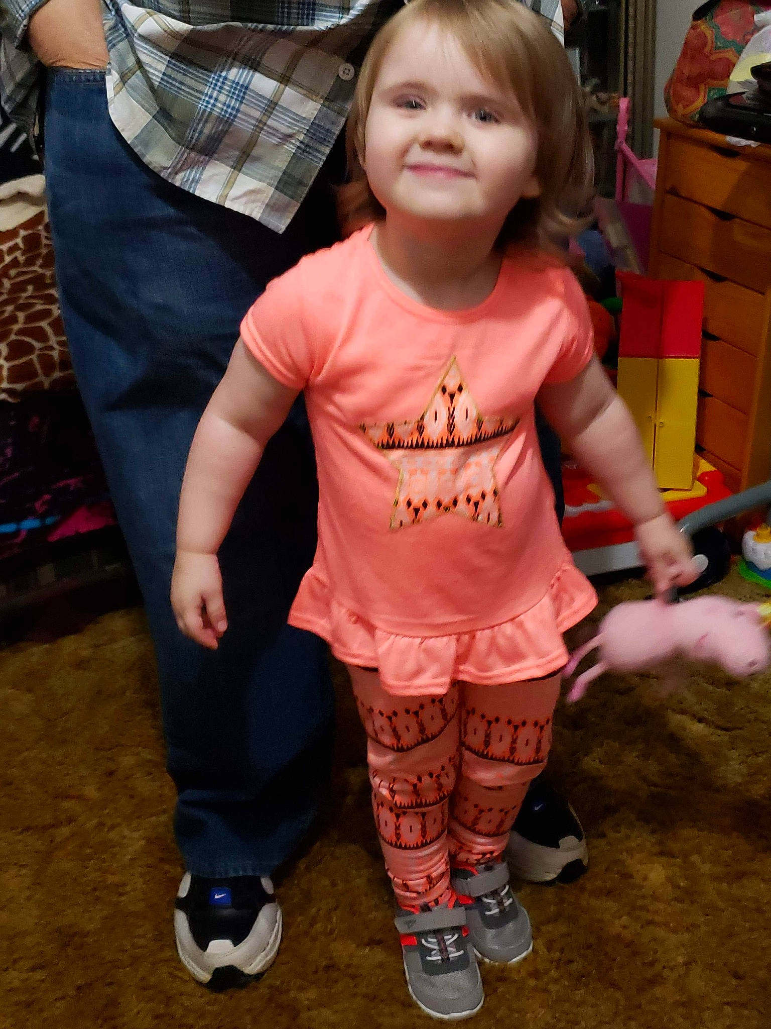 Rylee is registered to the contest to win money with this photo: cheek, child, joy, leg, person, shoe, skin, sleeve, smile, standing, t_shirt, toddler