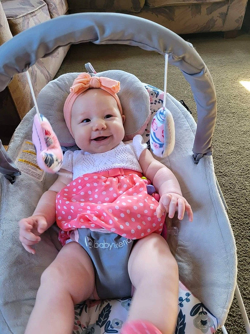 Kynlee joined the competition — help win amazing prizes! baby, baby_carriage, baby_toddler_clothing, chair, cheek, comfort, facial_expression, fun, grass, happy, headgear, headwear, joy, lap, leg, leisure, person, pink, product, skin