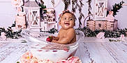 Ayla is registered to the contest to win money with this photo: baby, tub, milk, strawberry, flower, pink_rose, smile, headband, decor, wooden_floor, lantern, greenery, cute, sitting, infant, milk_bath, happy, portrait, flower_arrangement, indoor