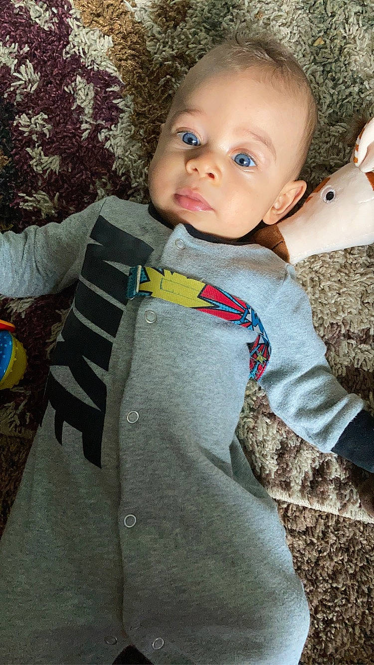 Christian Jr is registered to the contest to win money with this photo: baby, cheek, child, eye, face, head, nose, outerwear, person, skin, toddler