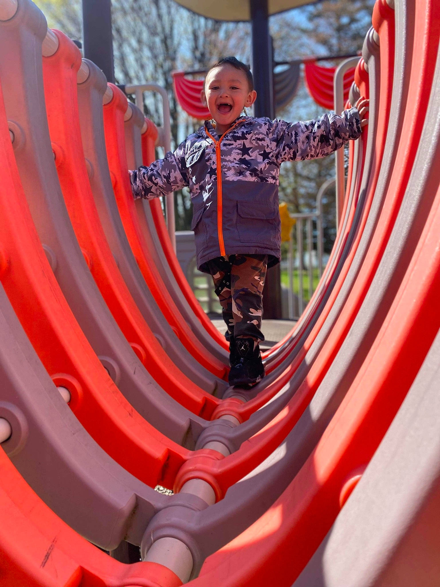 Ayden is registered to the contest to win money with this photo: amusement_park, auto_part, automotive_exterior, automotive_wheel_system, entertainment, event, festival, fun, leisure, magenta, outdoor_play_equipment, person, pink, playground, public_event, recreation, red, shorts, smile, t_shirt