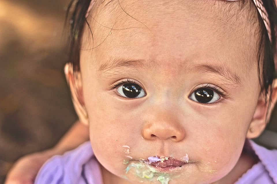Romani is registered to the contest to win money with this photo: cheek, child, close_up, ear, eating, eyebrow, face, forehead, head, infant, jaw, lip, mouth, nose, person, smile, toddler, tooth