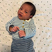 Lucas is registered to the contest to win money with this photo: baby, infant, striped_clothing, blanket, stars_pattern, lying_down, cute, small_hands, face, head, newborn, cozy, soft_texture, sleepwear, child, portrait, indoors, resting, young, adorable