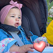 Nelya a rejoint le concours — aidez-le/la à gagner de superbes lots ! toddler, child, stroller, headband, denim_jacket, shoe, sneaker, heart_emoji, seatbelt, outdoor, curious, pink, blue, person, baby, clothing, footwear, seat, cute, infant