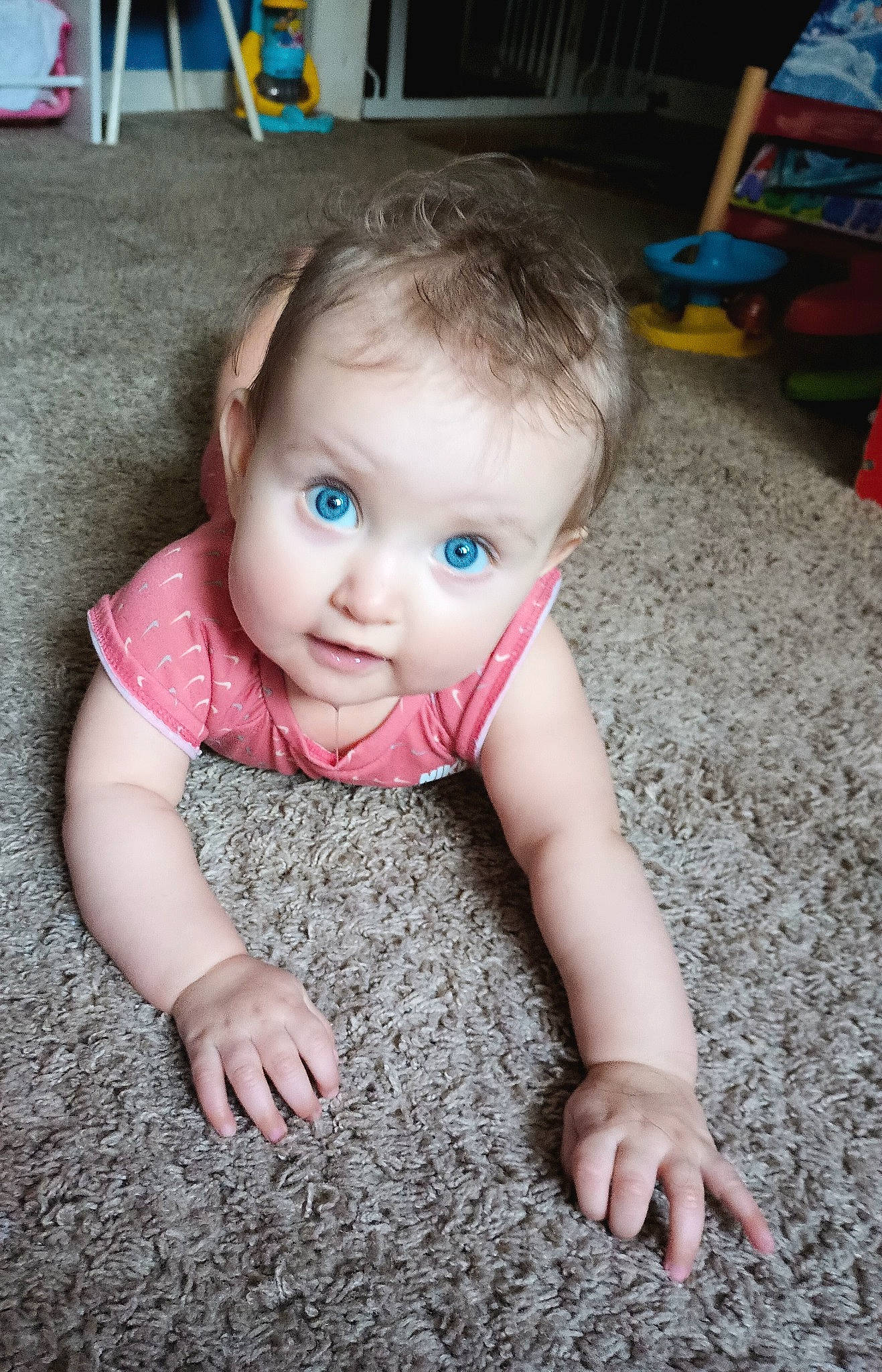 Gracelynn joined the competition — help win amazing prizes! baby, baby_toddler_clothing, blue, chair, cheek, crawling, eye, finger, floor, flooring, grass, human_body, iris, nose, person, photograph, skin, sleeve, smile, surprise