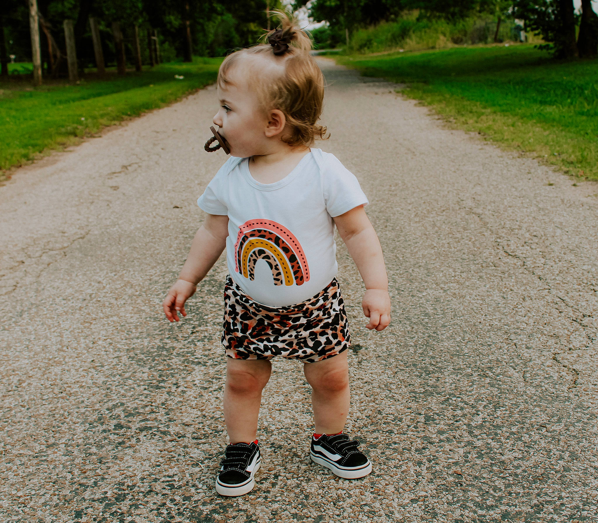 Addison is registered to the contest to win money with this photo: asphalt, baby, baby_toddler_clothing, child, cool, fun, grass, green, happy, human_leg, leisure, pattern, people_in_nature, person, plant, recreation, sleeve, smile, t_shirt, toddler