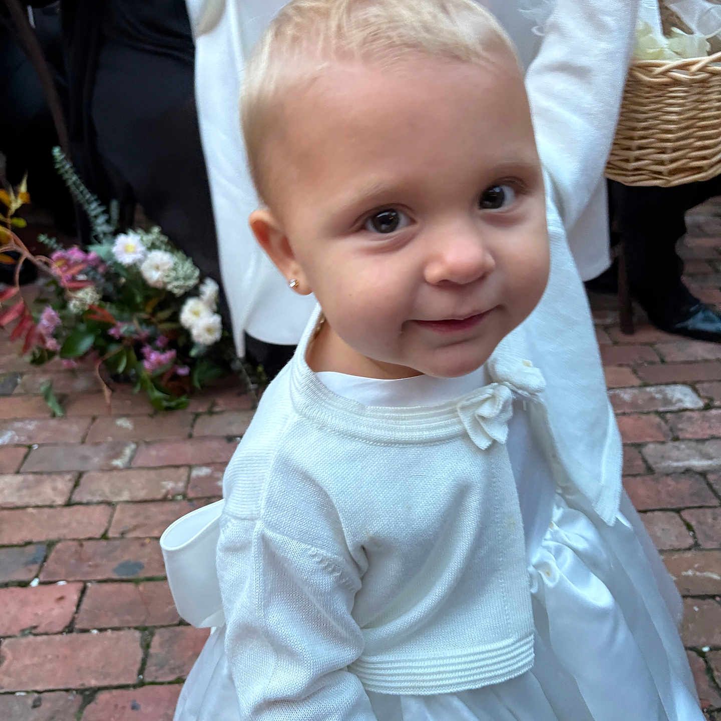 Addison joined the competition — help win amazing prizes! baby, basket, brick_floor, cardigan, child, cute, earrings, event, flower_arrangement, formal_wear, hand, holding_hand, outdoor, people, person, portrait, smiling, toddler, white_dress, young_child