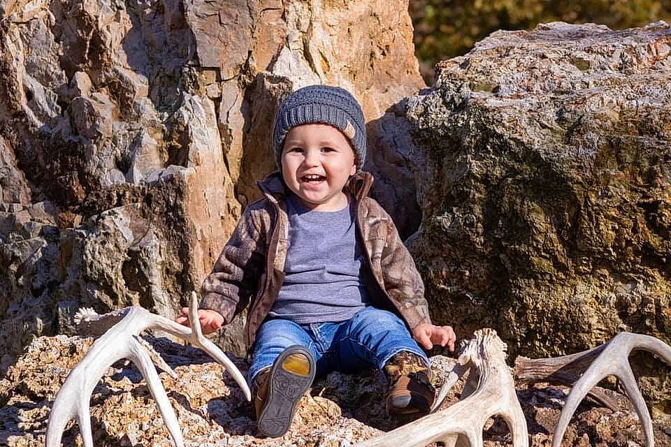 Conrad joined the competition — help win amazing prizes! child, fun, geological_phenomenon, geology, headwear, joy, leisure, person, photograph, photography, plant, portrait_photography, recreation, rock, sitting, smile, toddler, tree, wood