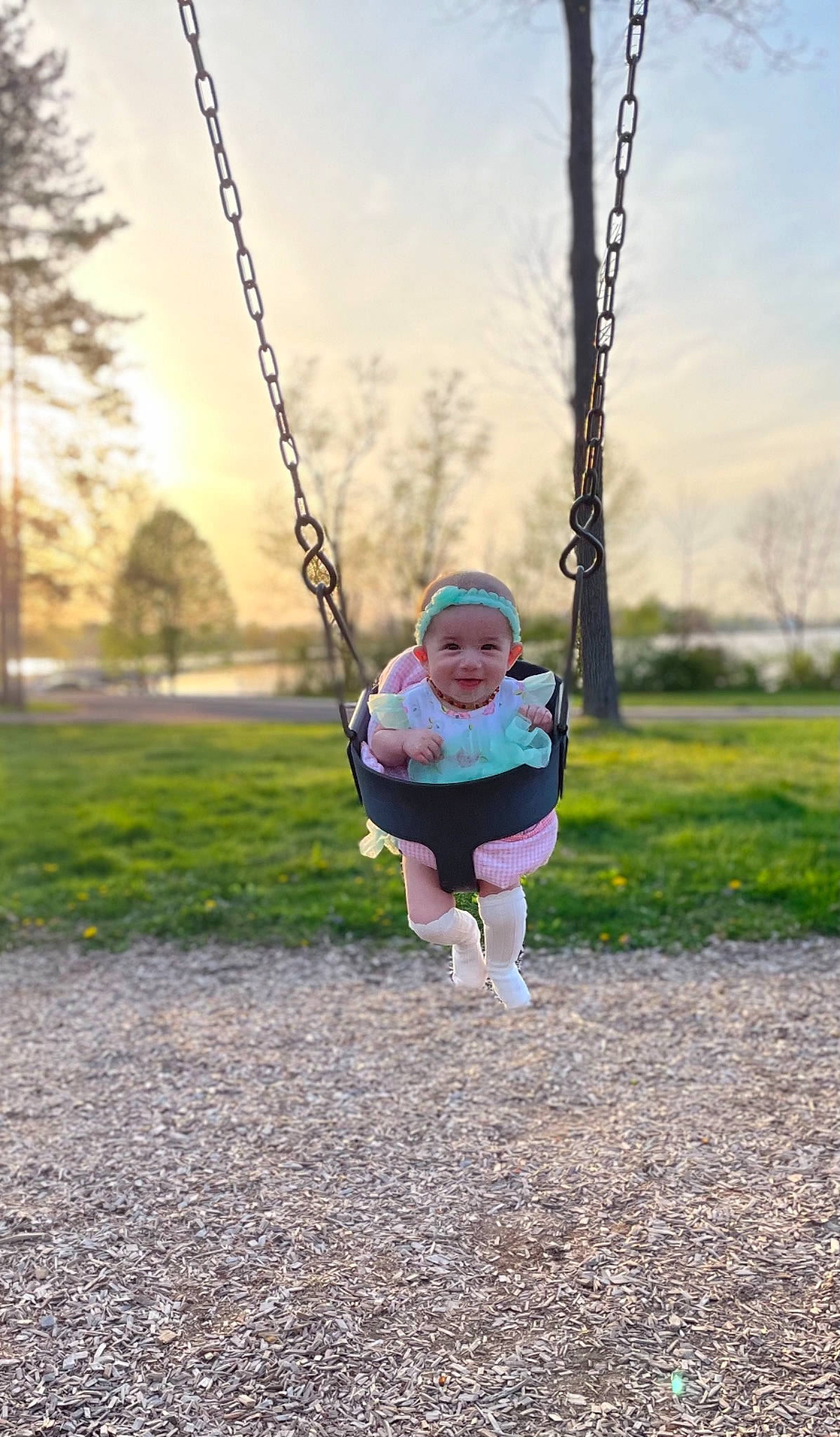 Rayne is registered to the contest to win money with this photo: baby, baby_toddler_clothing, branch, city, cloud, electric_blue, fun, grass, happy, headwear, joy, leisure, people_in_nature, person, plant, playground, recreation, sky, sleeve, swing