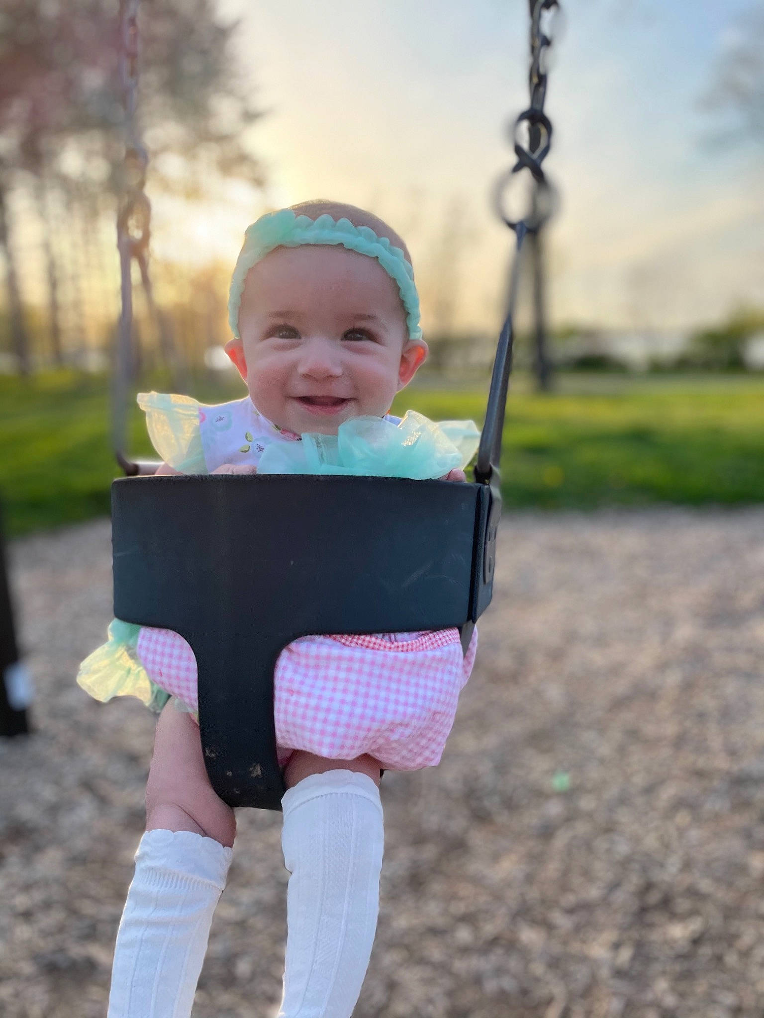 Rayne is registered to the contest to win money with this photo: baby, baby_toddler_clothing, eye, face, flash_photography, grass, happy, human_body, joy, leisure, person, pink, plant, playground, recreation, skin, sky, sleeve, smile, swing
