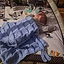Antoni joined the competition — help win amazing prizes! baby, blanket, blue, child, doll, floor, indoor, knitted, laying, mat, mobile_toys, person, playmat, soft, toy, wood_floor, young_child, infant, sleeping, cute
