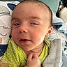 Judah joined the competition — help win amazing prizes! baby, infant, face, blanket, pillow, striped_clothing, hand, pacifier, sleepy, expression, closeup, skin, head, ear, soft_texture, child, indoors, resting, comfort, cute