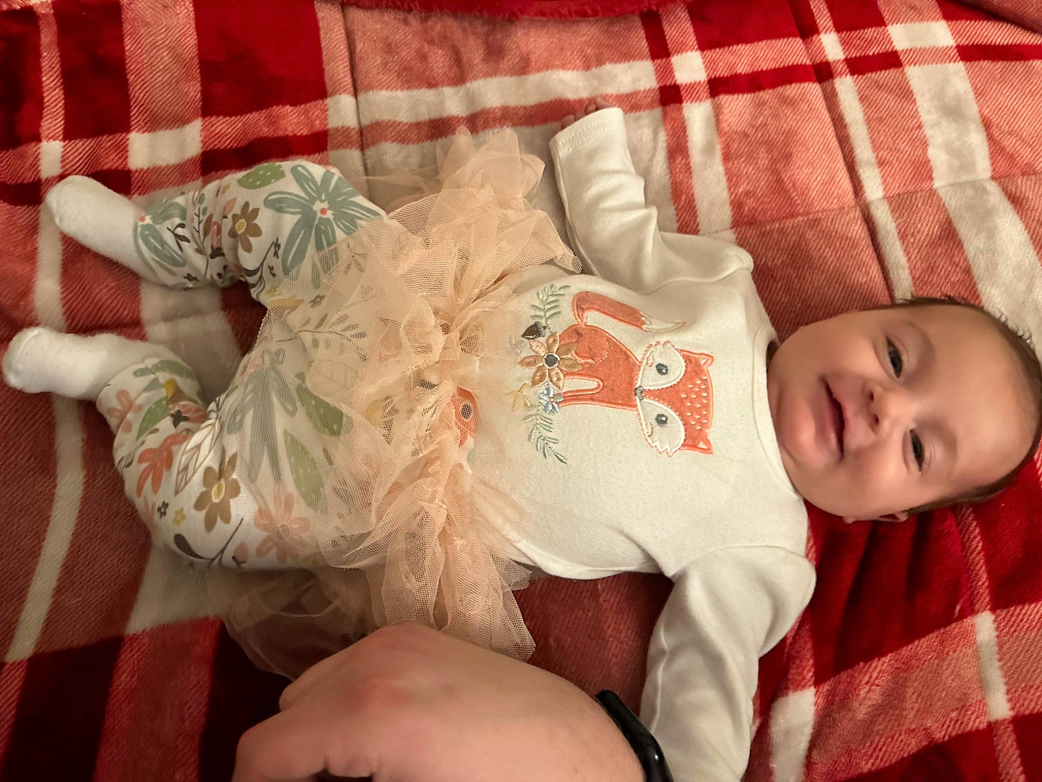 Addilyn is registered to the contest to win money with this photo: baby, baby_toddler_clothing, comfort, elbow, finger, human_body, human_leg, joy, knee, lap, leg, linens, mammal, mouth, pattern, person, skin, sleeve, textile, thigh