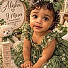 Alisha Roque is registered to the contest to win money with this photo: baby, child, portrait, sitting, curly_hair, hair_bow, green_dress, floral_dress, flowers, daisies, teddy_bear, wooden_blocks, nursery, garden_theme, smiling, indoors, close_up, decorative, greenery, milestone_photo