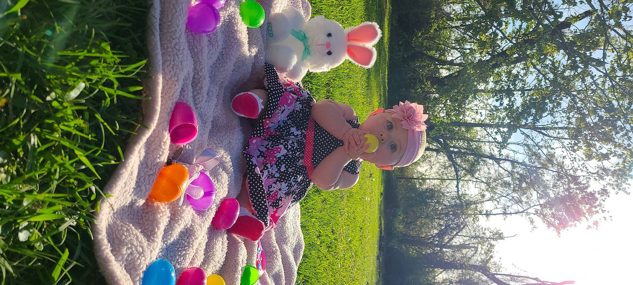 Vivian is registered to the contest to win money with this photo: botany, child, event, fun, grass, green, happy, hat, headwear, leaf, leisure, light, magenta, party_supply, pattern, people_in_nature, person, pink, plant, recreation