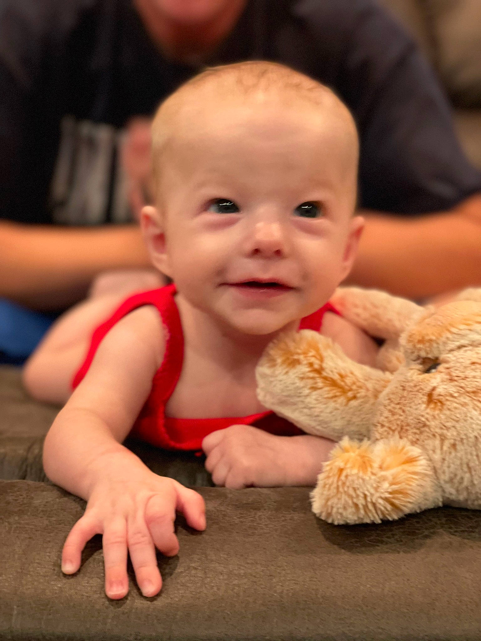 Jade is registered to the contest to win money with this photo: baby, baby_toddler_clothing, cheek, child, finger, flooring, fun, fur, happy, joy, person, plush, portrait_photography, sitting, skin, smile, stuffed_toy, teddy_bear, thumb, toddler