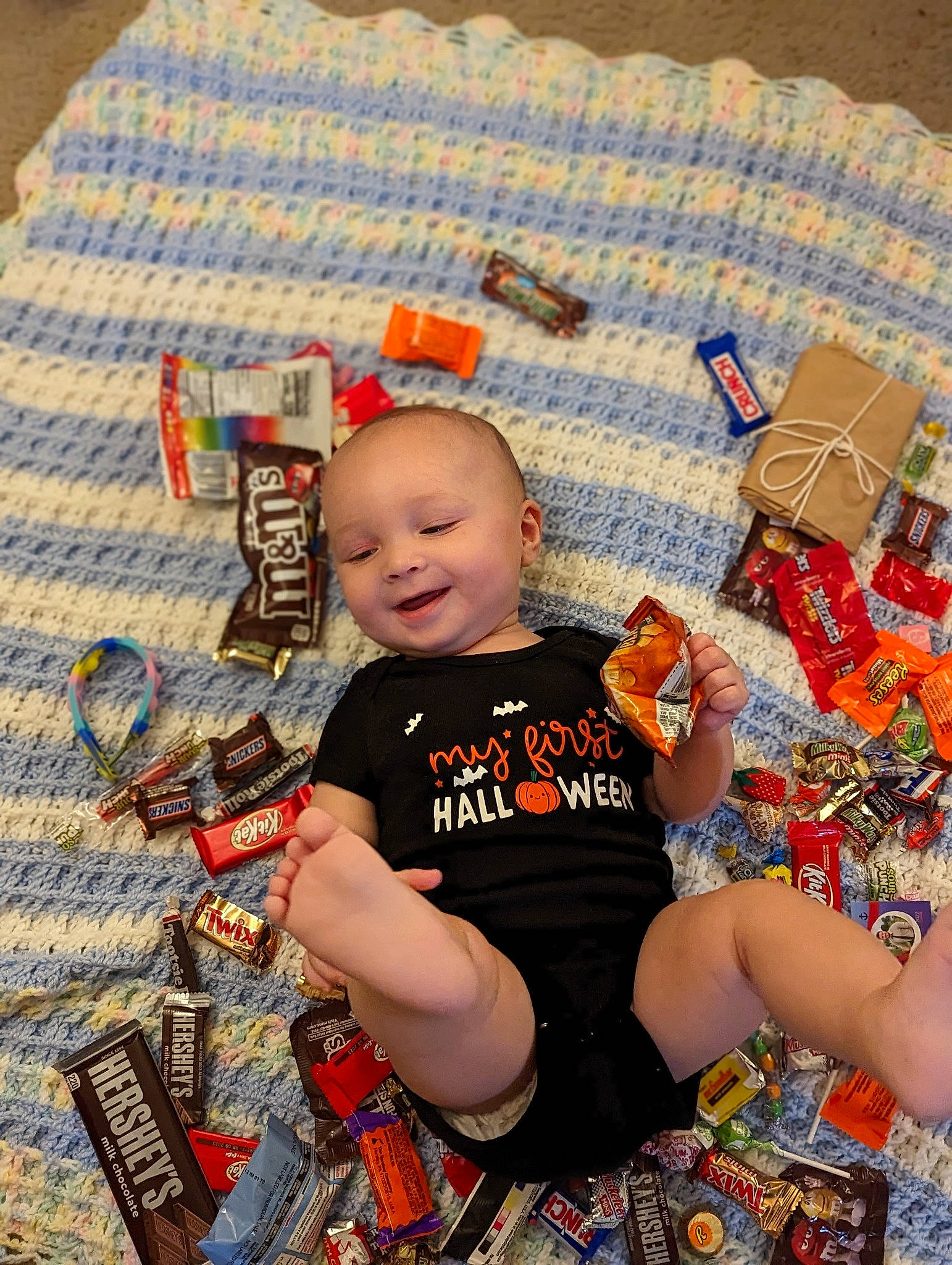 Kristian is registered to the contest to win money with this photo: baby, baby_products, baby_toddler_clothing, child, flooring, foot, fun, happy, head, human_leg, joy, lap, orange, pattern, person, play, shorts, sitting, sock, textile