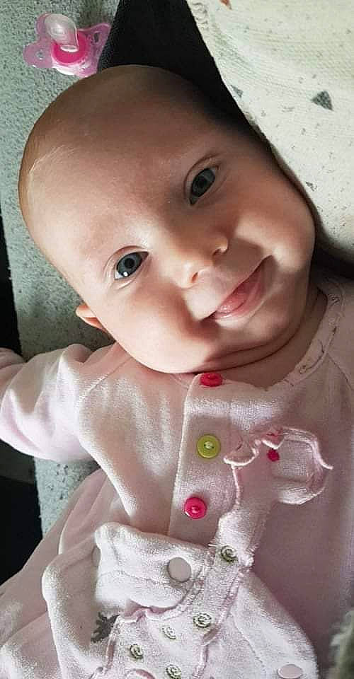 Victoria participe au concours pour gagner de l'argent avec cette photo : baby, baby_toddler_clothing, cheek, clothing, dress, eyebrow, eyelash, happy, headgear, iris, lip, mouth, neck, nose, person, pink, product, skin, sleeve, smile