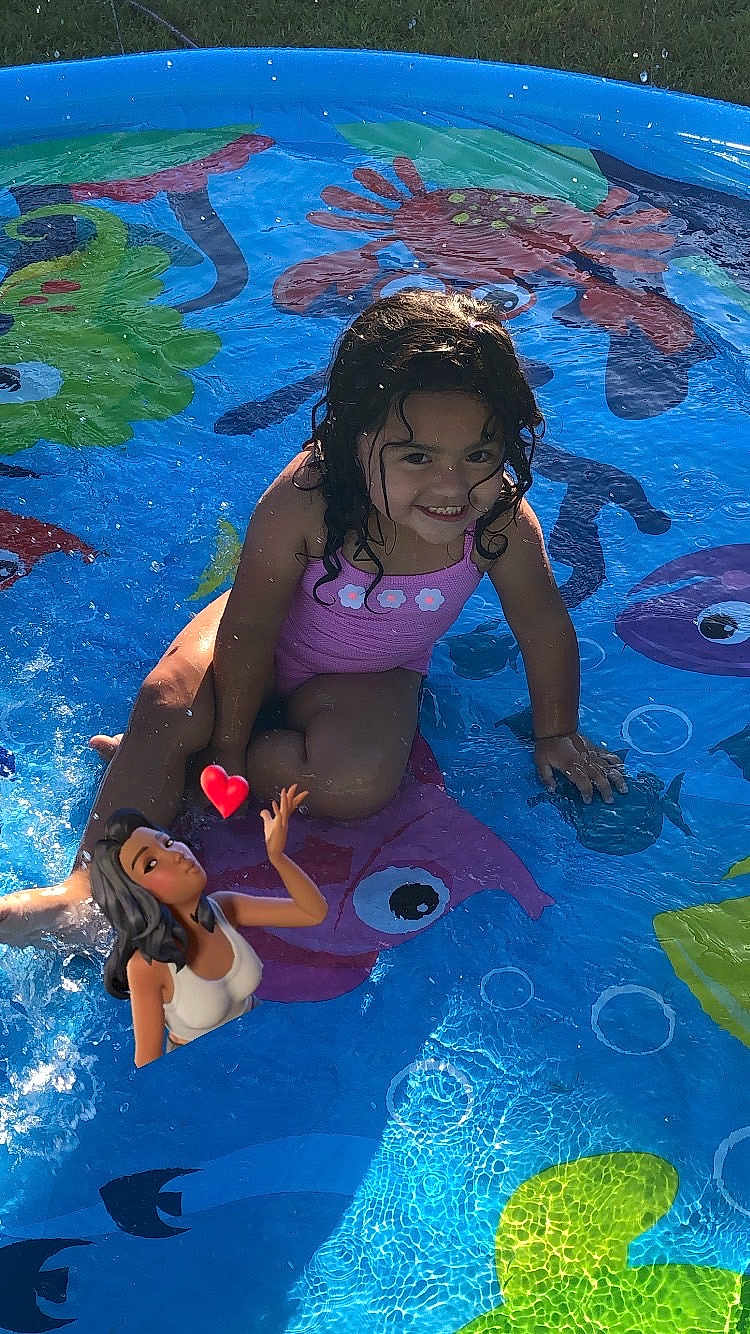 Alayna is registered to the contest to win money with this photo: child, pool, water, splash, swimsuit, smile, outdoor, summer, play, fun, grass, sunlight, cartoon, illustration, colorful, happy, cute, person, recreation, animation