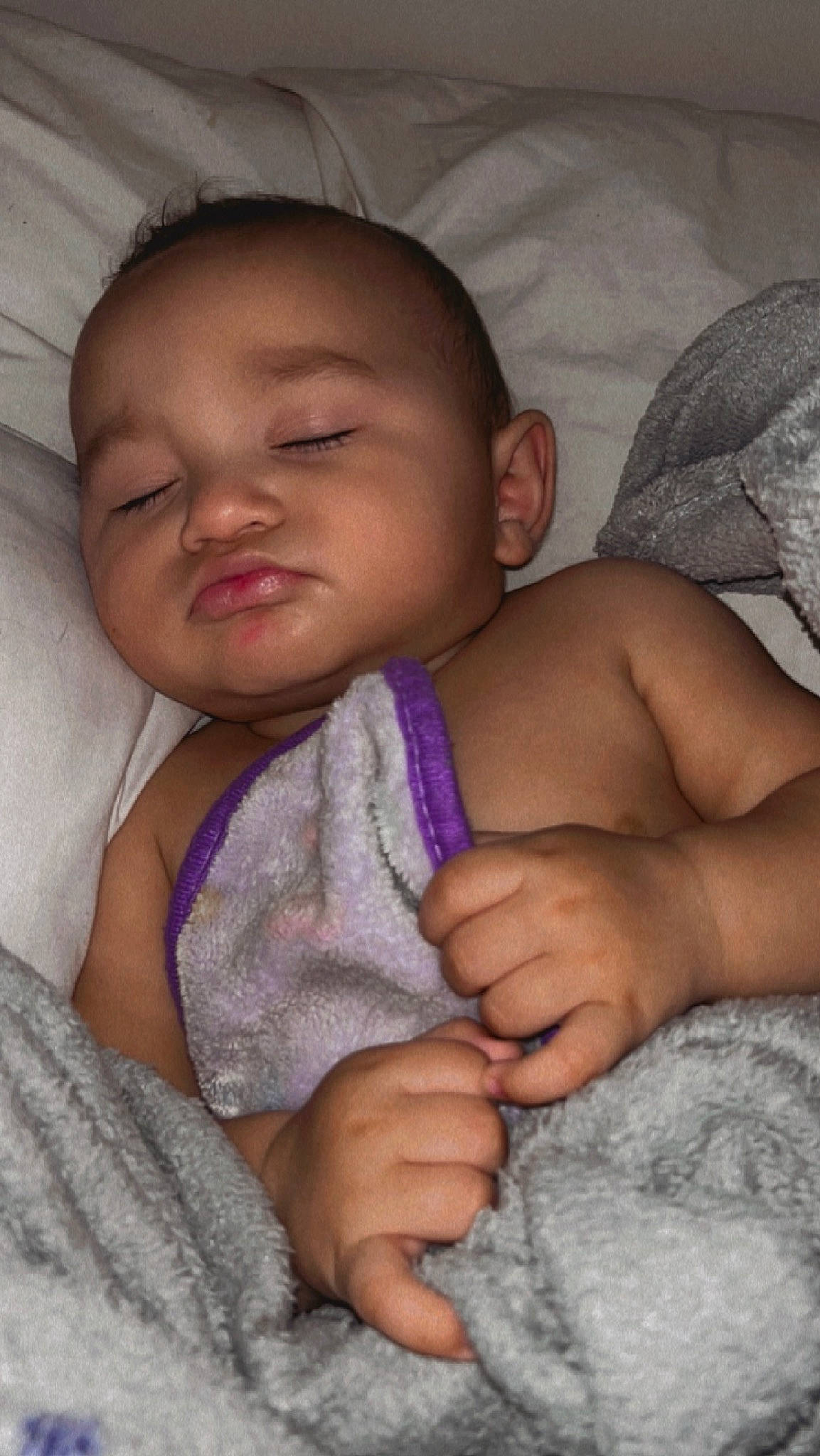 Grayson is registered to the contest to win money with this photo: baby, cheek, chin, comfort, eyebrow, facial_expression, finger, gesture, hand, human, iris, lip, mouth, neck, nose, person, pink, product, skin, textile