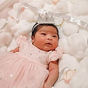 Aubrey joined the competition — help win amazing prizes! baby, infant, pink_dress, crown, headband, fluffy_cushions, soft_texture, newborn, portrait, cute, sleeping_area, indoor, adorable, child, celebration, soft_lighting, baby_girl, resting, closeup, cozy