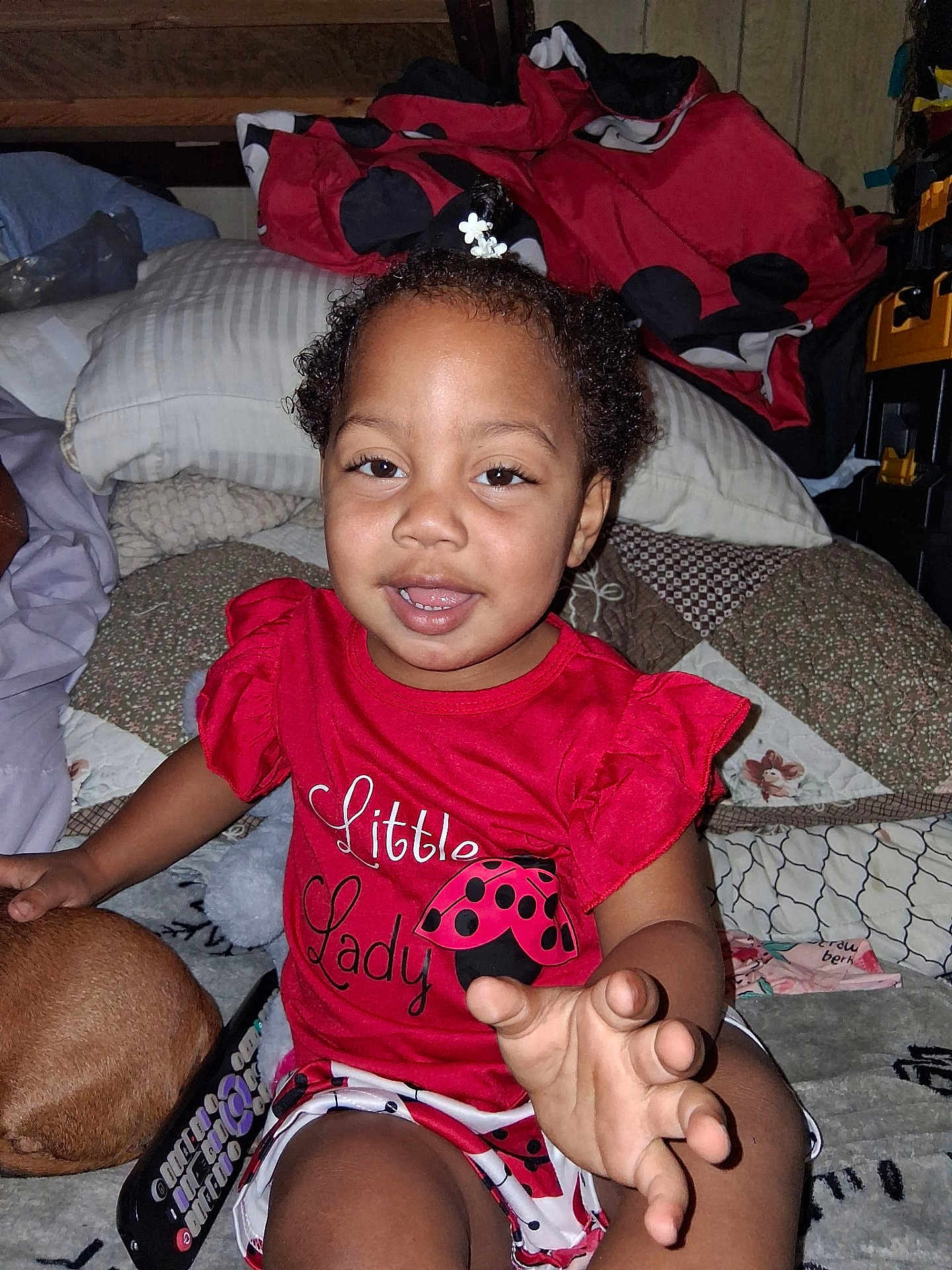 Kynslee joined the competition — help win amazing prizes! toddler, child, red_clothing, smiling, indoor, blanket, pillow, dog, curly_hair, cute, playful, young_child, person, home, casual, sitting, happy, face, hand, cozy