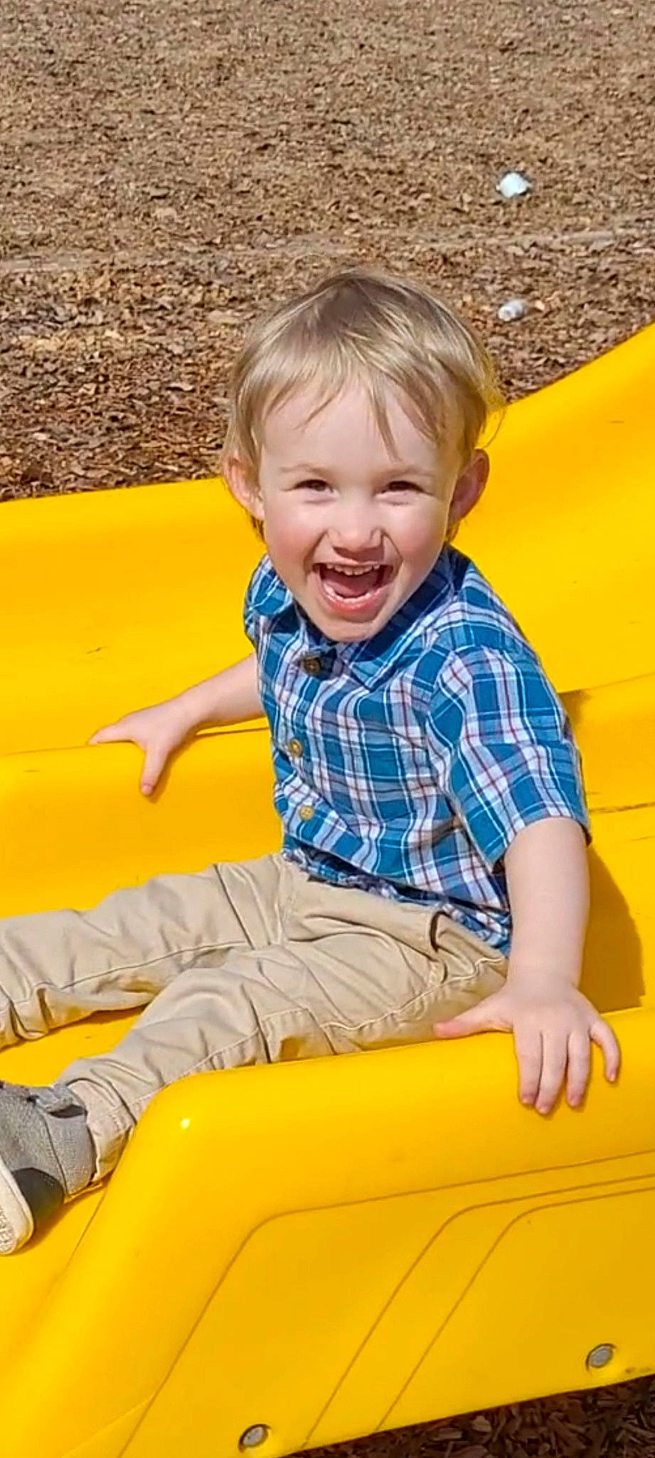 Jeremiah is registered to the contest to win money with this photo: baby_toddler_clothing, child, clothing, facial_expression, fun, grass, hairstyle, happy, joy, leisure, orange, outdoor_play_equipment, person, public_space, recreation, sleeve, smile, standing, summer, t_shirt