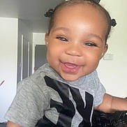 Brielle is registered to the contest to win money with this photo: toddler, child, smiling, happy, indoor, gray_shirt, hair_bows, baby, person, portrait, cute, black_hair, expression, young_child, joy, human, face, skin, casual_clothing, holding_hand