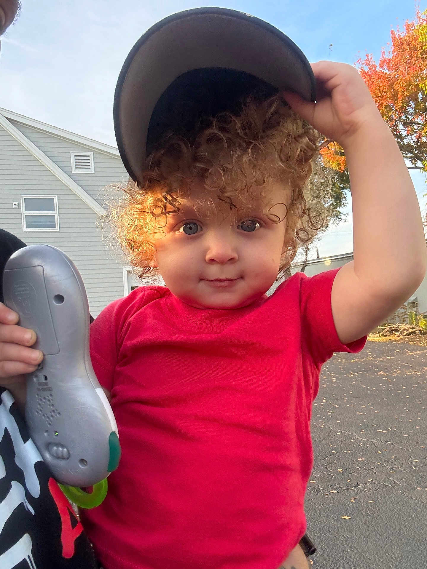 P.j joined the competition — help win amazing prizes! child, toddler, curly_hair, red_shirt, cap, toy, outdoor, daylight, house, tree, autumn, playful, person, face, hand, expression, street, casual_clothing, nature, holding