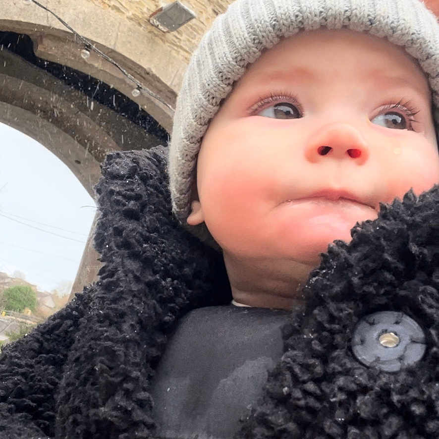 Sonny is registered to the contest to win money with this photo: animal, baby, baseballcap, beanie, bodypart, bonnet, brick, canine, cap, clothing, coat, doll, face, finger, fleece, glove, hand, happy, hat, head