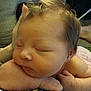 baby, newborn, sleeping, face, arm, hand, skin, hair, patterned_fabric, closeup, resting, peaceful, infant, portrait, child, soft_light, indoors, human, cute, relaxed