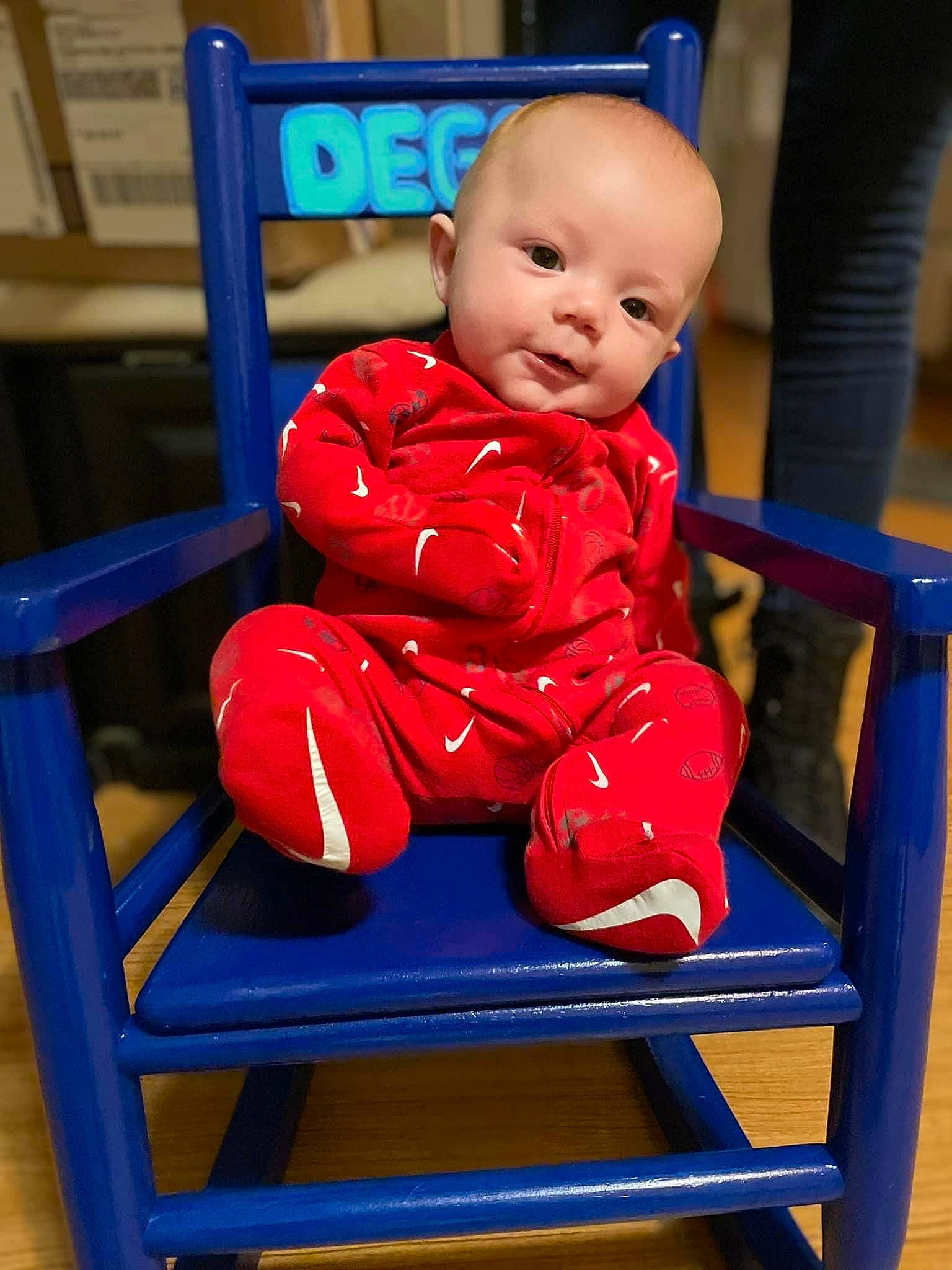 Degan is registered to the contest to win money with this photo: baby, baby_toddler_clothing, blue, chair, cheek, child, comfort, electric_blue, fun, happy, head, human_leg, leisure, person, play, rectangle, red, sitting, sleeve, toddler