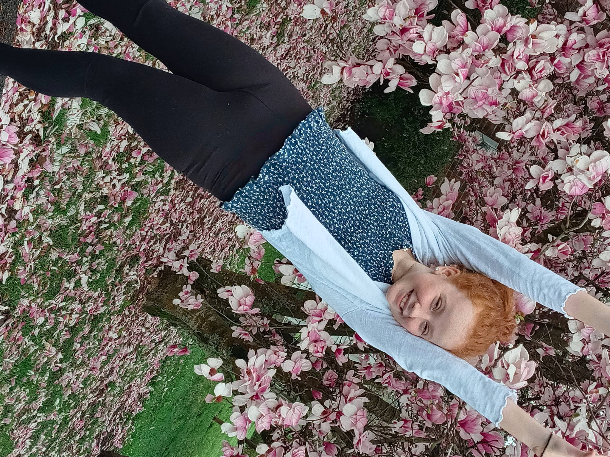 Abigail is registered to the contest to win money with this photo: active_pants, blossom, branch, flower, flowering_plant, gesture, grass, groundcover, joy, leisure, magenta, people_in_nature, person, petal, pink, plant, purple, smile, textile, thigh