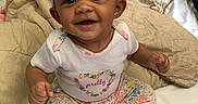 Hazellbelle joined the competition — help win amazing prizes! baby, bed, blanket, bow, child, clothing, cute, floral_pants, happy, headband, indoors, infant, orange_socks, person, pillows, pink, portrait, sitting, smiling, white_shirt