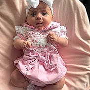 Nevaeh joined the competition — help win amazing prizes! baby, infant, child, pink, white, bow, headband, dress, blanket, sitting, cute, portrait, soft, sock, lace, clothing, face, hands, legs, indoor